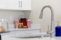 Kitchen counter with two red-and-white striped popcorn boxes flanking a red blender, plus green cans and a snack tray on the counter.