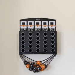 Black wall-mounted mini basketball arcade with multiple holes and a hanging net catching orange and black balls