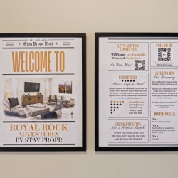 Two framed posters mounted on a beige wall; left one says 'WELCOME TO ROYAL ROCK ADVENTURES BY STAY PROPR' with a living room image, right one lists guest info like Wi‑Fi and house rules as sections.